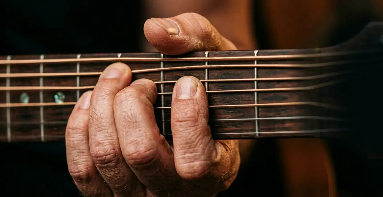 Close-up of musician's hands performing precise finger movements on musical instrument demonstrating coordination and technique