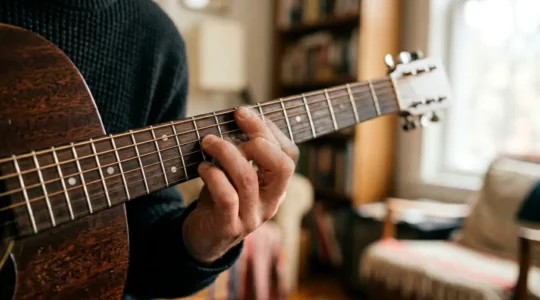 Close-up hands on instrument transitioning from structured scale practice to expressive improvisation