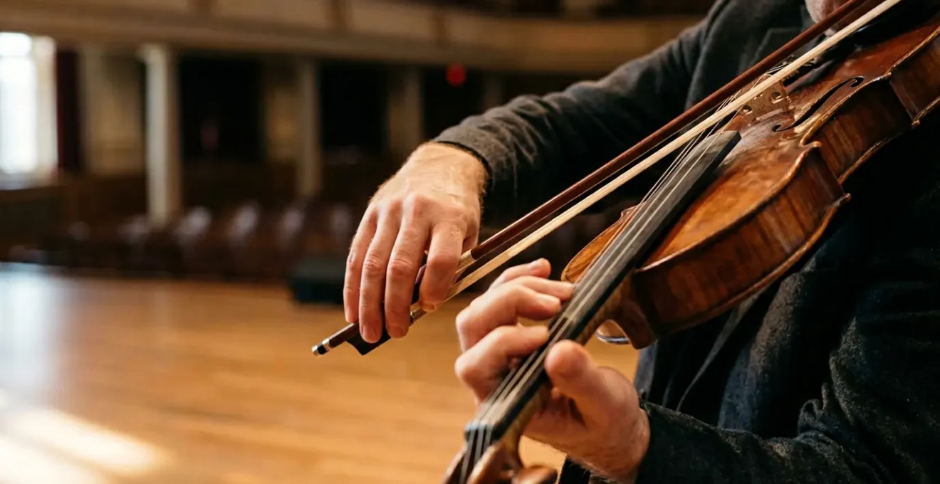 Close-up of violinist hands demonstrating expressive bowing technique with focused intensity