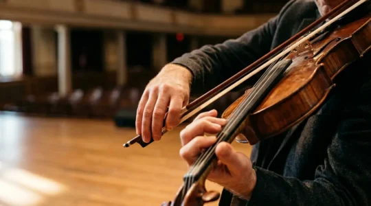 Close-up of violinist hands demonstrating expressive bowing technique with focused intensity