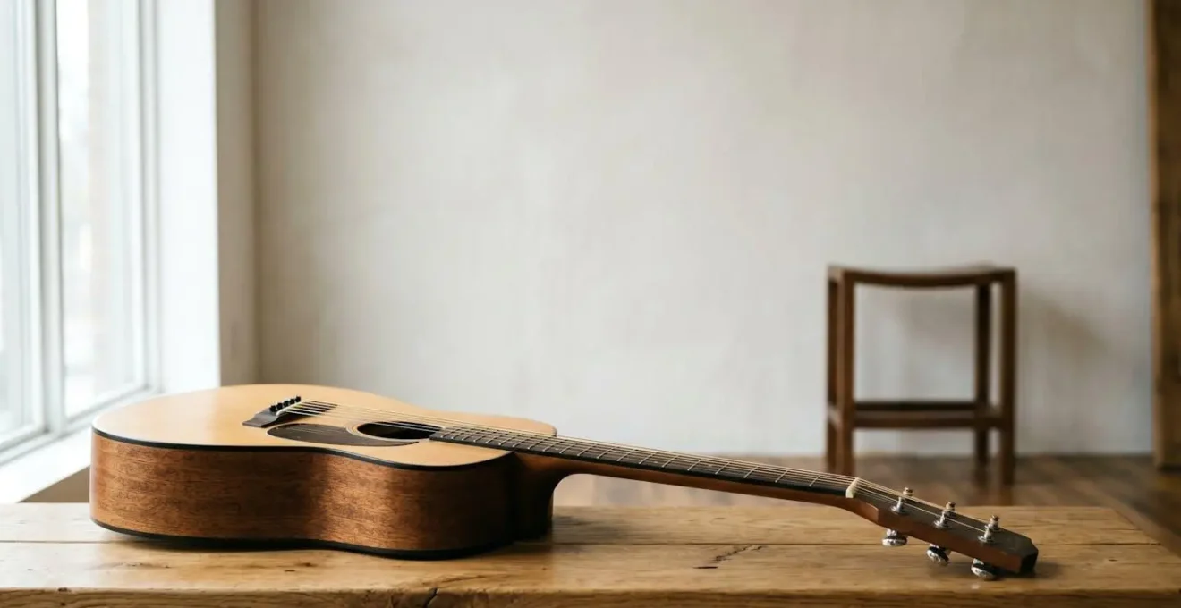 Wide environmental shot of acoustic guitar in creative studio space with tuning focus