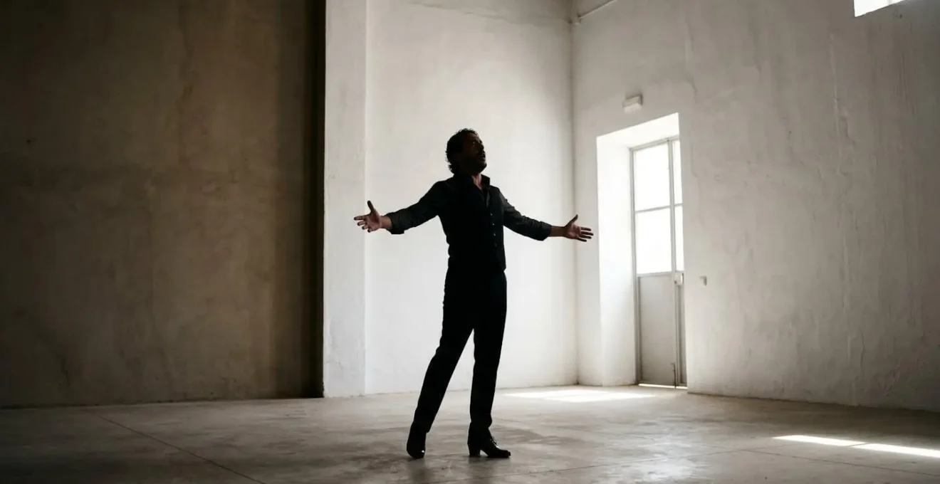 Silhouetted flamenco performer in moment of cathartic vocal release against minimal background
