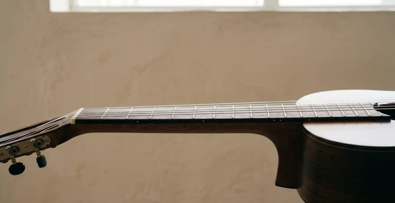 Side profile view of classical guitar neck showing string height relationship to fretboard with natural depth and spatial clarity
