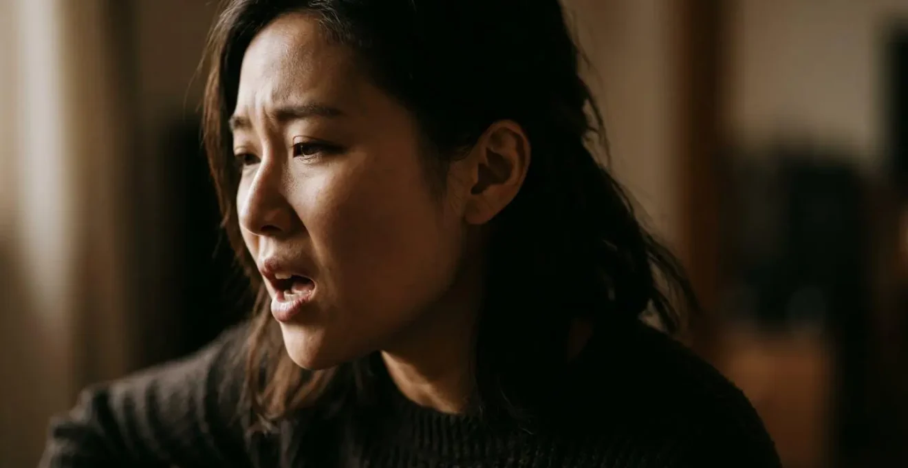 Close-up profile of a vocalist's face during an emotionally intense singing moment, captured mid-phrase with dramatic natural lighting