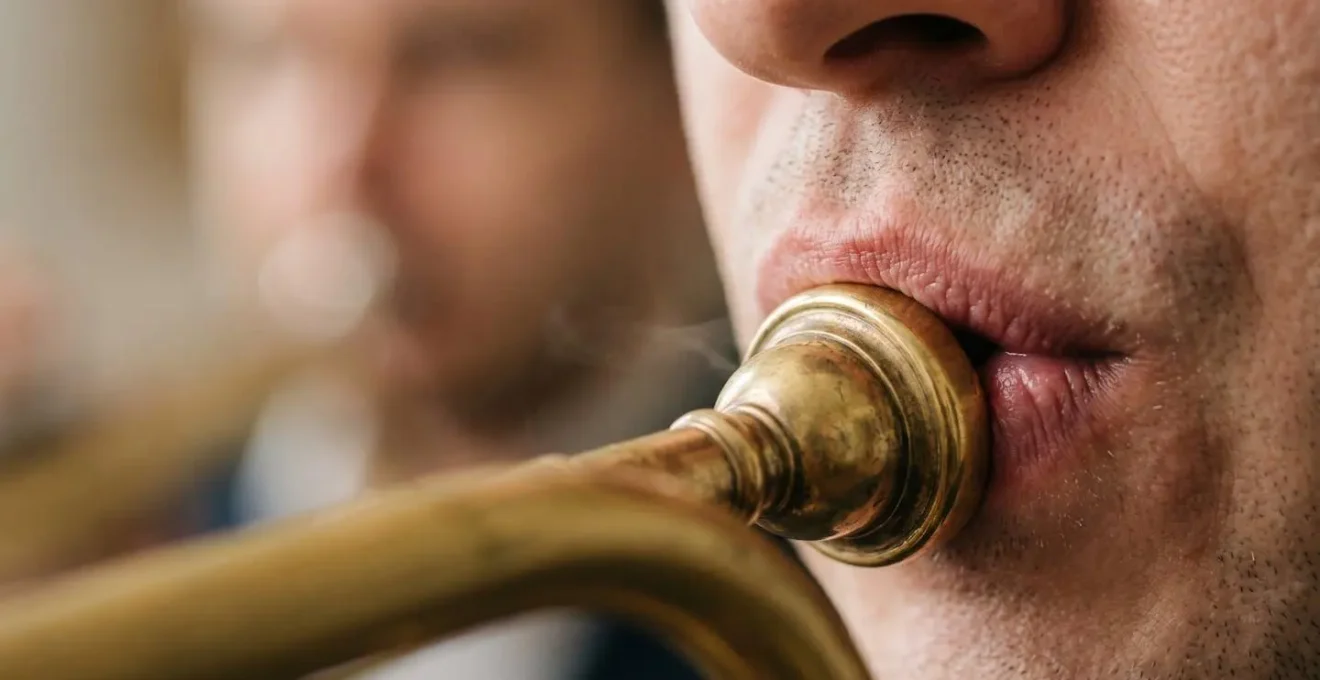 Close-up detail of embouchure and mouthpiece contact during sustained long tone exercise