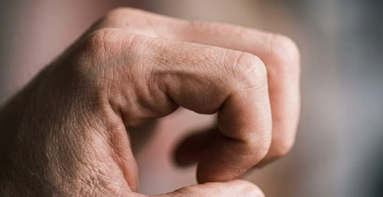 Extreme macro photograph of hand tendons and fingers in motion showing textural detail during gliding exercise
