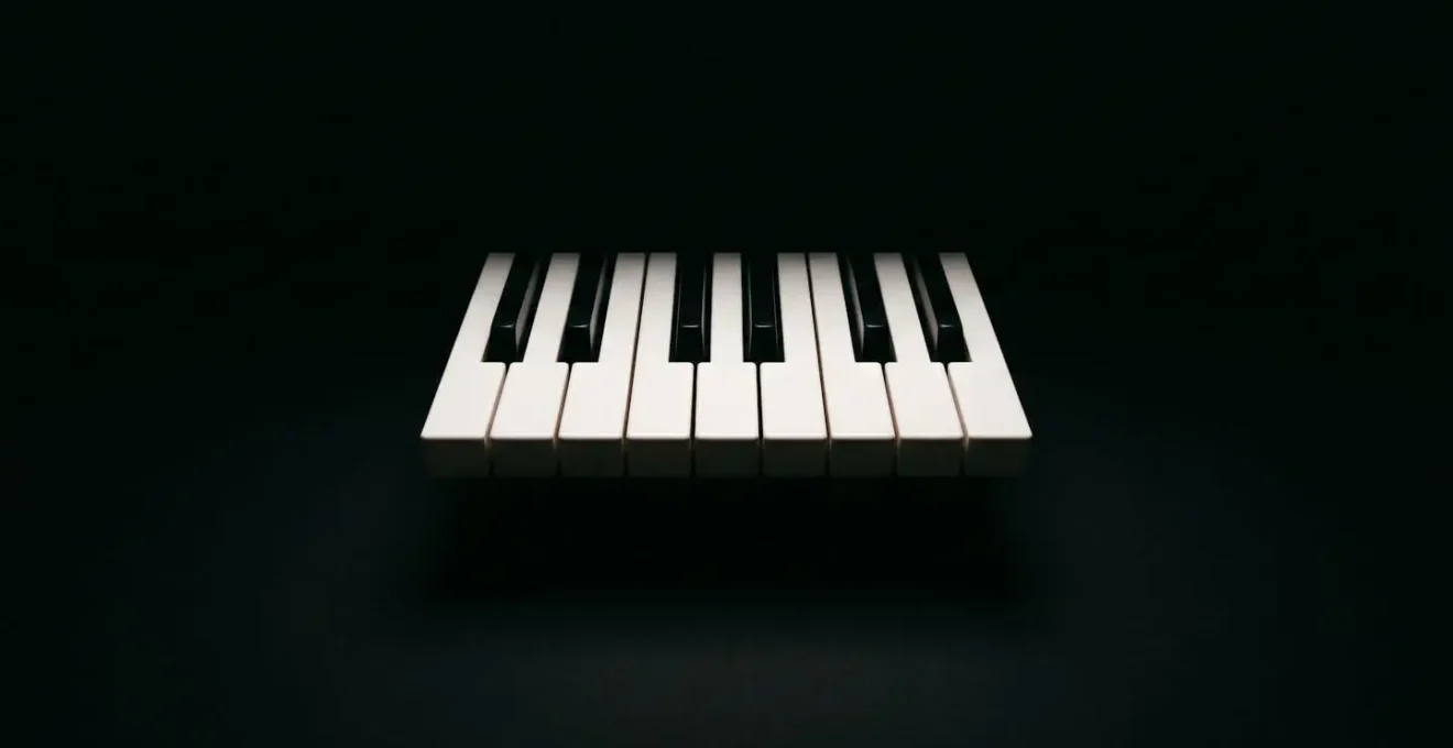 Minimalist wide shot of five piano keys illuminated against a dark background, creating visual simplicity