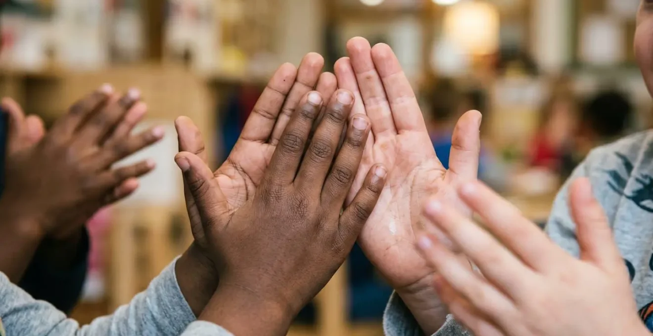Close-up of children's hands clapping in rhythm demonstrating phonological awareness development